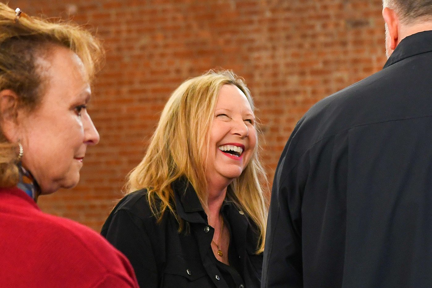 A guest laughing at the firm's 2026 annual client meeting